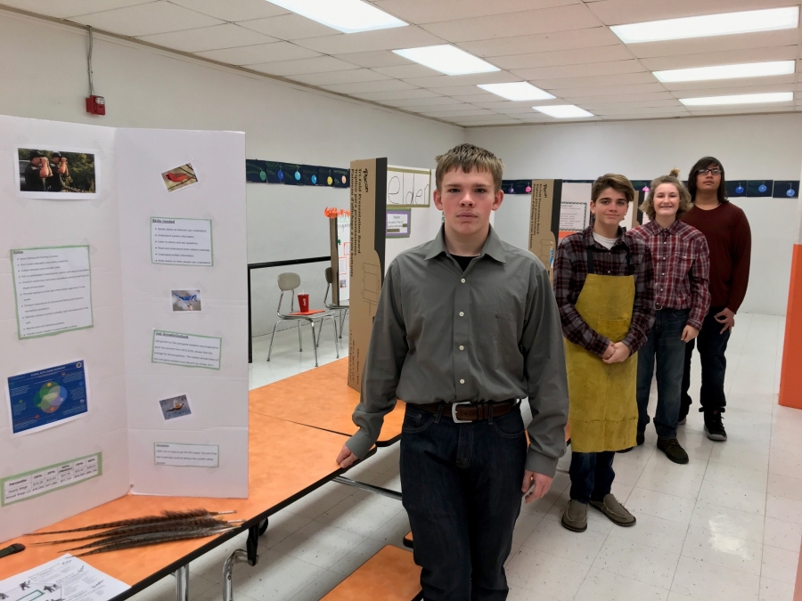 students behind a tri board project